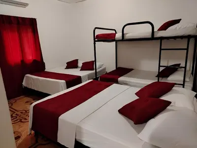 a room with three bunk beds with red pillows at Apartamento por noches en Doradal in Las Mercedes