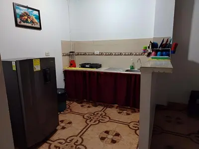 a kitchen with a table and a counter with a sink at Apartamento por noches en Doradal in Las Mercedes