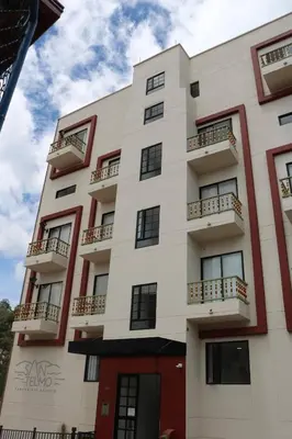 a white building with windows and balconies at Apartment with a hot tub and a view of Guatapé lake in Guatapé