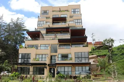 a building on top of a hill at Apartment with a hot tub and a view of Guatapé lake in Guatapé