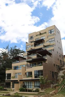 an apartment building with balconies on the side of it at Apartment with a hot tub and a view of Guatapé lake in Guatapé