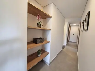 a hallway of a house with wooden shelves at Apartment with a hot tub and a view of Guatapé lake in Guatapé