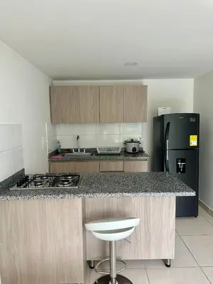 a kitchen with a counter top and a black refrigerator at Sector Turistico, Confort y Full Amoblado in Manizales
