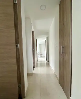 an empty hallway with white walls and wooden doors at Sector Turistico, Confort y Full Amoblado in Manizales