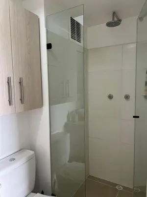 a bathroom with a toilet and a glass shower at Estancias confortables, amigos y familia in Manizales