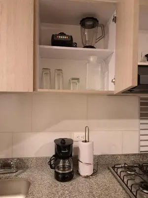 a kitchen counter with a sink and a coffee maker at Estancias confortables, amigos y familia in Manizales