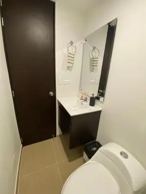 a bathroom with a toilet and a sink and a mirror at Estancias confortables, amigos y familia in Manizales