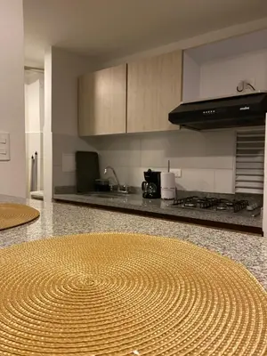 a kitchen with a large circular rug on the floor at Estancias confortables, amigos y familia in Manizales
