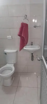 a bathroom with a toilet and a sink at Hotel Estadero Piscina EL CACIQUE GUARKAMA in Montañadentro