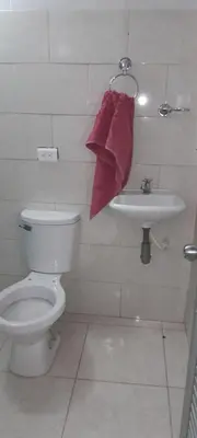 a bathroom with a toilet and a sink at Hotel Estadero Piscina EL CACIQUE GUARKAMA in Montañadentro
