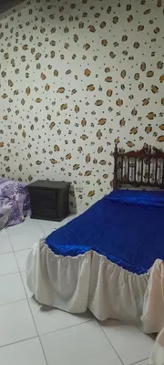 a bedroom with a bed and a wall with seashells at Hotel Estadero Piscina EL CACIQUE GUARKAMA in Montañadentro