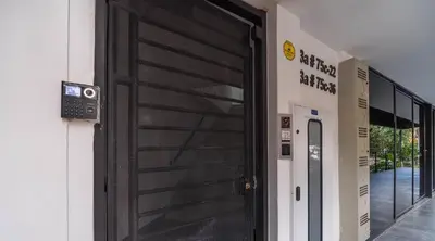 a black door on the side of a building at Cozy Spring Flat in Laureles in Medellín