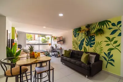 a living room with a couch and a table at Cozy Spring Flat in Laureles in Medellín