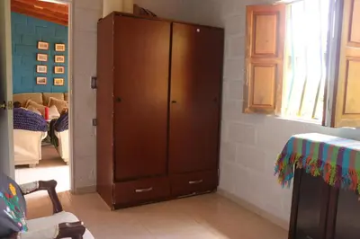 a large wooden cabinet in a living room at Casa Finca El Peñol Antioquia in El Peñol
