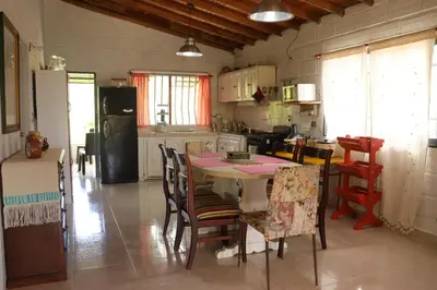 a kitchen with a table and chairs and a refrigerator at Casa Finca El Peñol Antioquia in El Peñol