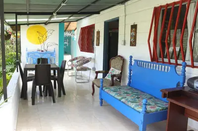 a dining room with blue chairs and a table at Casa Finca El Peñol Antioquia in El Peñol