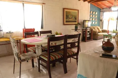 a living room with a table and chairs at Casa Finca El Peñol Antioquia in El Peñol