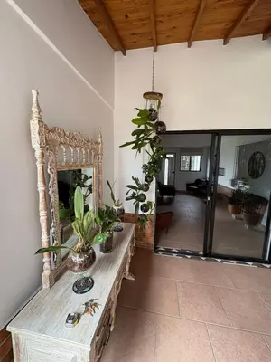 a living room with a table with plants on it at Casa San Antonio de Pereira in Rionegro
