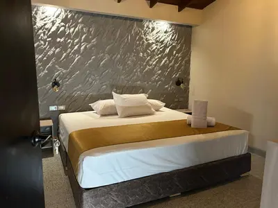 a bedroom with a bed with a silver wall at Casa Kyros Boutique in Medellín