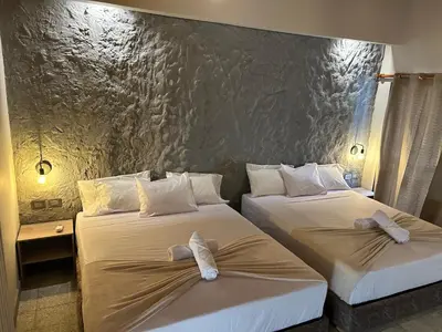 a hotel room with two beds with bows on them at Casa Kyros Boutique in Medellín
