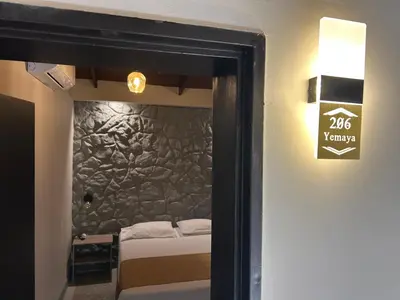 a room with a bed with a stone wall at Casa Kyros Boutique in Medellín