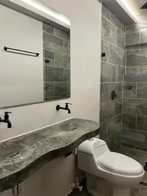 a bathroom with a toilet and a shower at Casa Kyros Boutique in Medellín