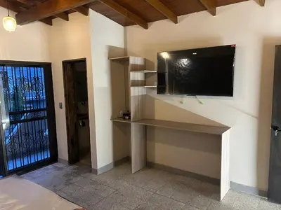 a living room with a flat screen tv on a wall at Casa Kyros Boutique in Medellín