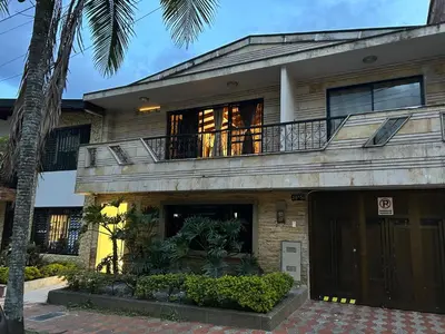 a house with a balcony on top of it at Casa Kyros Boutique in Medellín