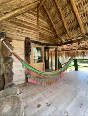 a hammock in the middle of a house at Cabaña ecologica en el Rio Cocorna, Puerto Triunfo in Providencia