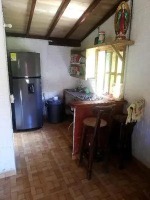 a kitchen with a refrigerator and a table and chairs at Casa Arcolibri in San Rafael