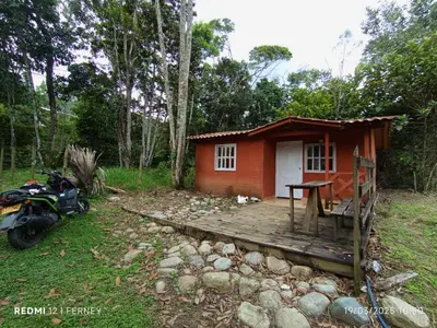 a small red house with a motorcycle parked in front of it at Casa Arcolibri in San Rafael