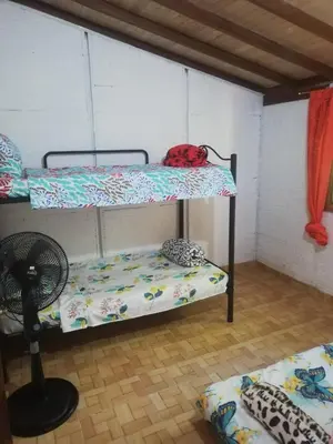 a room with two bunk beds and a fan at Casa Arcolibri in San Rafael