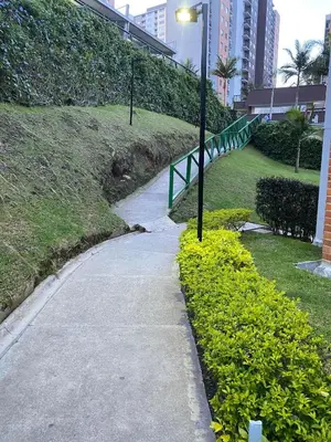 a sidewalk next to a grassy hill with a street light at Ap entero en Rionegro cerca Aiport JMC ,Int in Rionegro