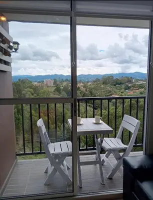 a table and chairs on a balcony with a view at Ap entero en Rionegro cerca Aiport JMC ,Int in Rionegro