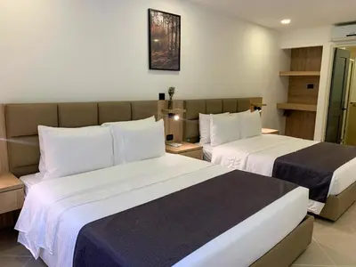 a hotel room with two beds in a room at Hotel Poblado Boutique in Medellín