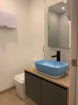 a bathroom with a blue sink and a toilet at Hotel Poblado Boutique in Medellín