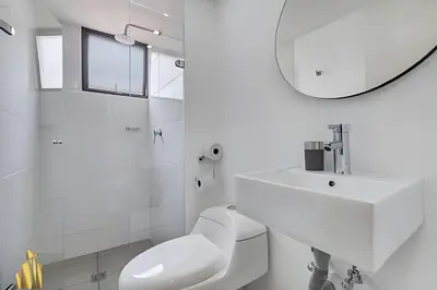 a white bathroom with a toilet and a sink at Ankara 301 - Contemporary Loft Trendy in provenza in El Poblado