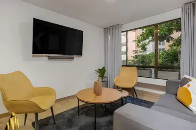 a living room with a couch and chairs and a tv at Ankara 302 - Clean Comfy Loft Trendy in Provenza in El Poblado