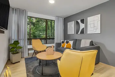 a living room with a blue couch and yellow chairs at Ankara 302 - Clean Comfy Loft Trendy in Provenza in El Poblado