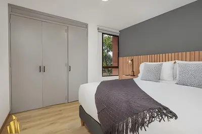 a bedroom with a large white bed and a window at Ankara 302 - Clean Comfy Loft Trendy in Provenza in El Poblado