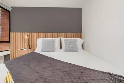 a bedroom with a large bed with white sheets and pillows at Ankara 302 - Clean Comfy Loft Trendy in Provenza in El Poblado