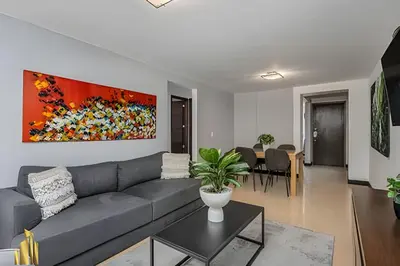 a living room with a couch and a painting on the wall at Ankara 401 - Modern and comfort Apt in Provenza in El Poblado