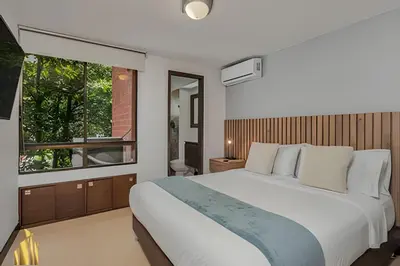 a bedroom with a large white bed and a window at Ankara 401 - Modern and comfort Apt in Provenza in El Poblado