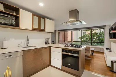 a kitchen with white cabinets and a stove top oven at Ankara 402 - Private bright apt/ Provenza in El Poblado