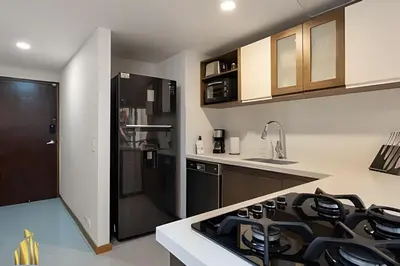 a kitchen with a black stove top oven next to a counter at Ankara 402 - Private bright apt/ Provenza in El Poblado
