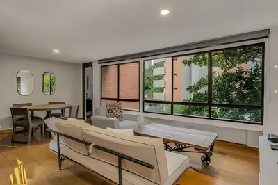 a living room with chairs and a table and a large window at Ankara 402 - Private bright apt/ Provenza in El Poblado
