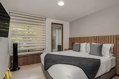 a bedroom with a large bed and a window at Ankara 501 - Modern Apt inside Provenza with AC in El Poblado