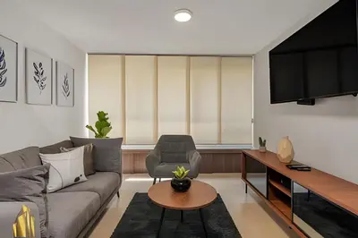a living room with a couch and a tv at Ankara 501 - Modern Apt inside Provenza with AC in El Poblado