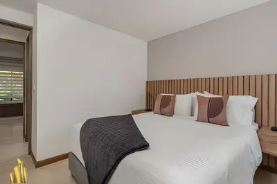 a bedroom with a large white bed with pillows at Ankara 501 - Modern Apt inside Provenza with AC in El Poblado