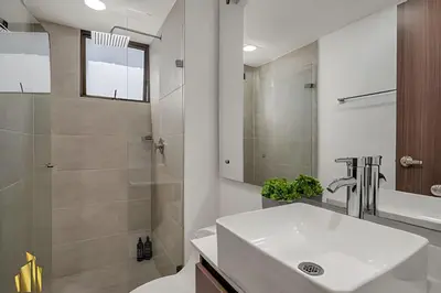 a white bathroom with a sink and a shower at Ankara 501 - Modern Apt inside Provenza with AC in El Poblado